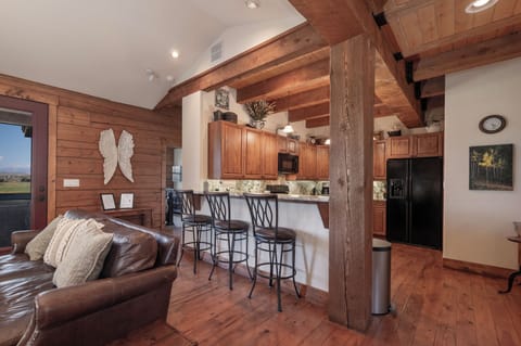 - Open kitchen bar with seating for casual morning coffee   - Spacious wood interior flows into living room area   - Great spot for family chats and relaxed dining moments