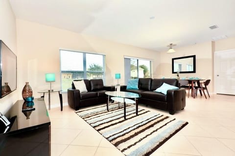 Open plan living space with access to the pool and deck