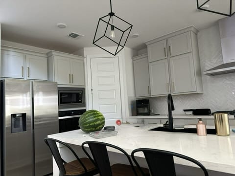 refrigerator, spacious island, dishwasher, oven, stove, microwave