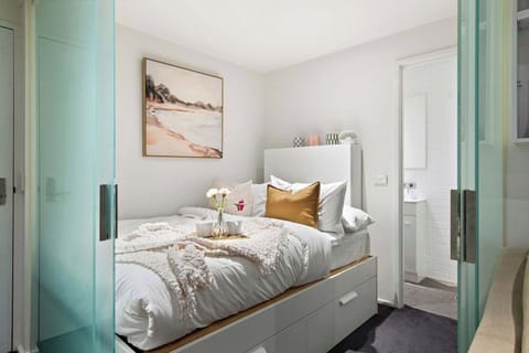 A bedroom area with a double sized bed & plush pillows.