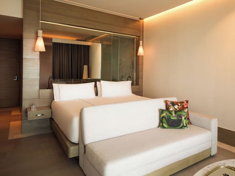 Sink into plush bedding and relax on the cozy lounge sofa.