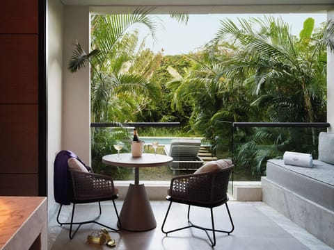 Toast the evening on your private terrace surrounded by palms.