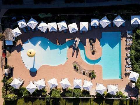 Picture your day poolside with roomy loungers and umbrellas.