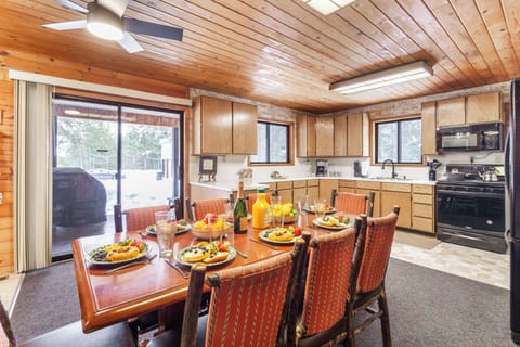 Gather around the inviting dining table in this spacious kitchen, fully equipped and perfect for sharing meals and making memories at Raven's Retreat.