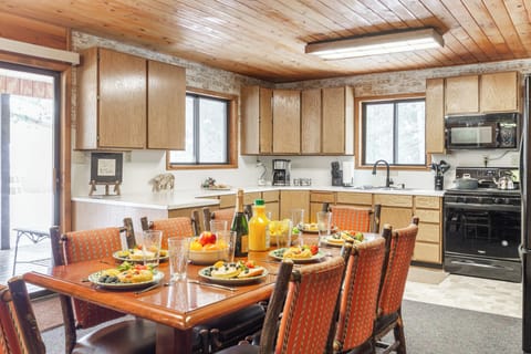 Gather for delicious meals in this bright, welcoming kitchen and dining area, thoughtfully designed for memorable moments at Raven's Retreat.