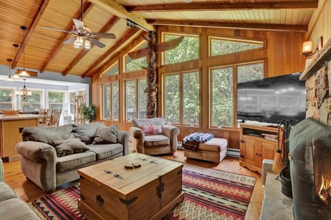 Cozy Living Room with Wood Beams and Large Windows