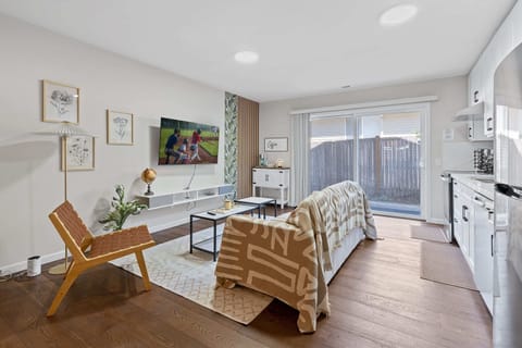 Bright and cozy living room with modern decor, perfect for relaxing after a day of exploring the city.