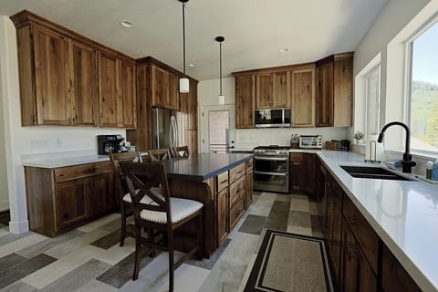Main Kitchen - Features plenty of counter and cabinet space, common kitchen appliances, tons of cookware and diningware.
