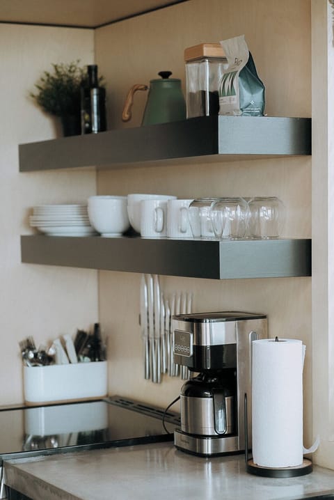 Full kitchen with electric range, fridge, microwave, and coffeepot. S+P, coffee, olive oil