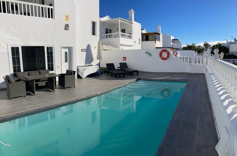 Comfy poolside seating with lots of sun loungers