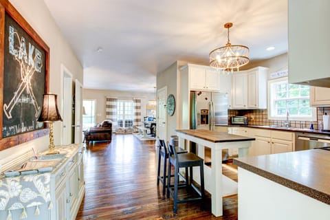 Kitchen located on main level upon entry of the home- entrance to living and dining spaces