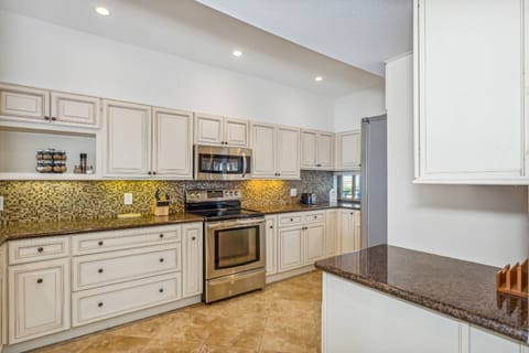 Fully equipped kitchen with upgraded cabinets and lighted blacksplash