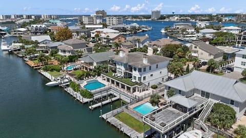 Take in the breathtaking aerial view of our property and neighborhood, where the serene waterfront adds to the charm of the landscape