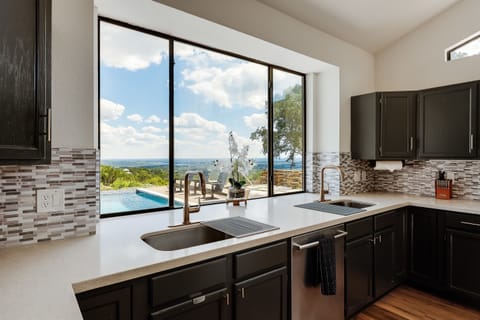 Kitchen with large windows - bringing in natural light and showcasing the beautiful scenery outside.