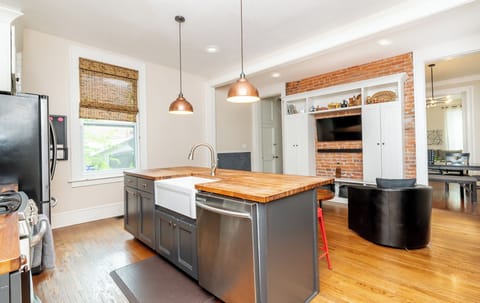 Large butcher block island with farmhouse sink