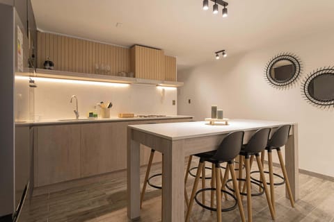 Sleek kitchen with ample seating and modern design, ideal for culinary gatherings.