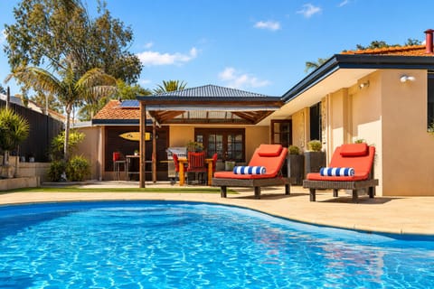 Outdoor seating by the pool with pool towels provided at every stay