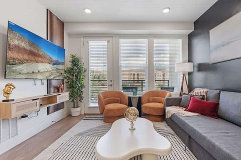 Enjoy the perfect balance of light and nature in our living room, featuring a bamboo plant and artful touches.