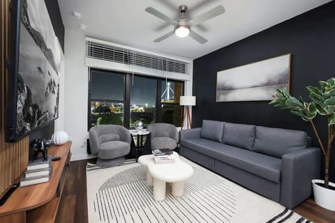 Relax in a living room filled with light, art, and comfort, featuring cozy chairs, a long sofa, and a mini center table.