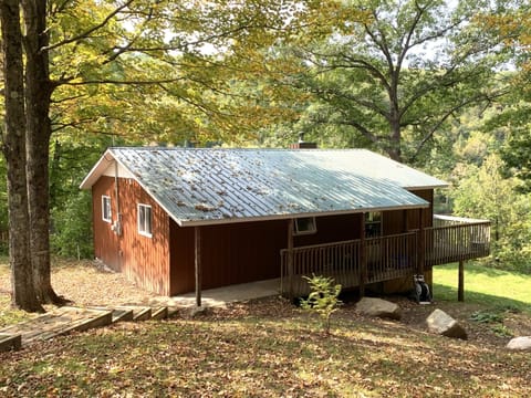 Sheltered under mature sugar maples, this is a view of cottage from driveway