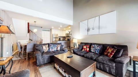 Open living space with fireplace, TV, and balcony