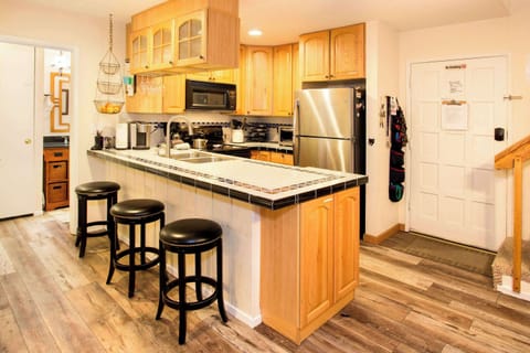 Full kitchen with toaster, drip coffee maker, Keurig coffee maker, kettle, wine ware