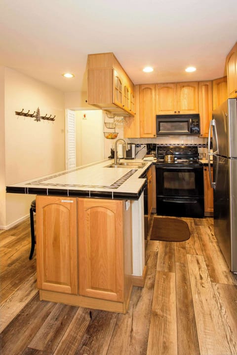 Full kitchen with toaster, drip coffee maker, Keurig coffee maker, kettle, wine ware