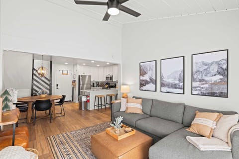 Living room with TV, gas fireplace, balcony access, and sofa sleeper