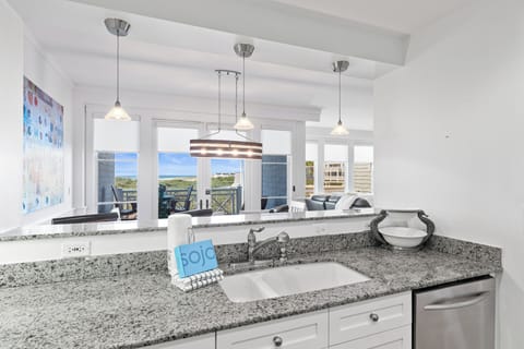 Your open kitchen flows seamlessly into the living area, with granite counters and ocean views inspiring your culinary adventures.