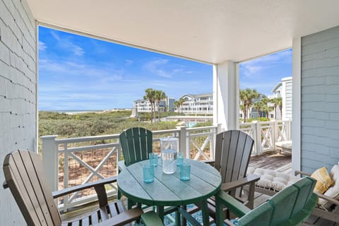 Your private balcony overlooks coastal scenery, where you can sip morning coffee in colorful Adirondack chairs while palm trees sway nearby.
