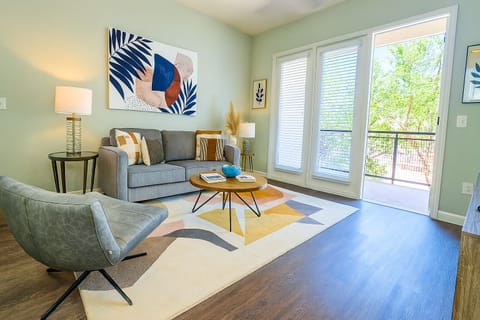 Bright living room with natural light and serene outdoor view.