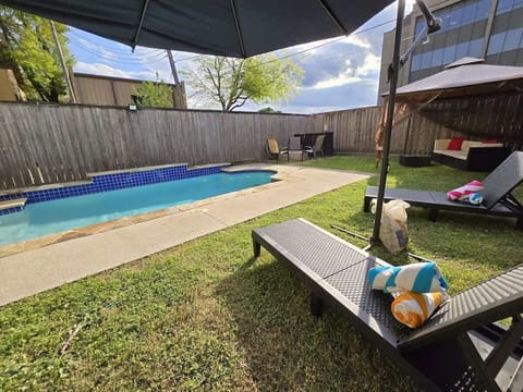 Lounge under shade beside your sparkling pool and hammock escape.