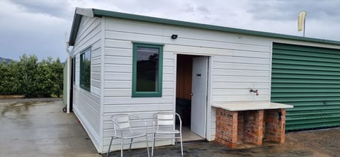 Outdoor furniture, fish cleaning station to the right.