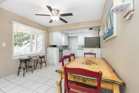 Charming dining nook with seating for four and bistro seating for two, located just off the kitchen for easy meals
                