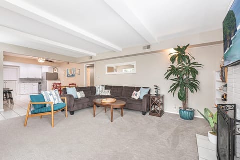 Open-concept living area featuring comfortable sofas and plenty of room to unwind after a day on the sand
                