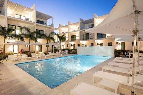 Large swimming pool with chaise loungers and umbrellas