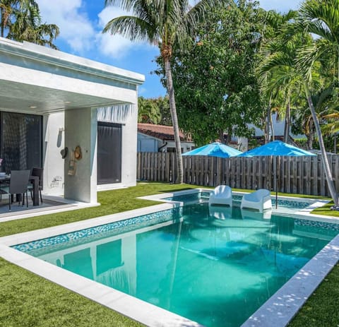 Backyard with dining table for 6, heated pool with tanning shelf  and 2 loungers