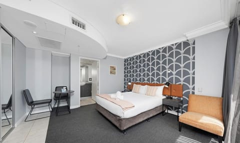 Bright, comfortable bed with fresh linens.