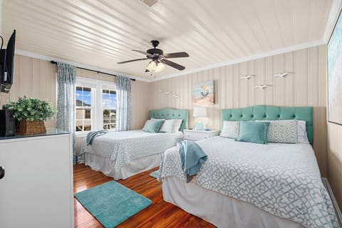 Enjoy restful nights in this charming bedroom, featuring two comfortable beds and plenty of natural light.