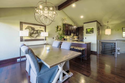 Dine at our elegant farmhouse table under a statement chandelier, with seating for six and open sightlines to the kitchen.