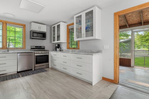 Marble counters, modern appliances, and easy outdoor access.