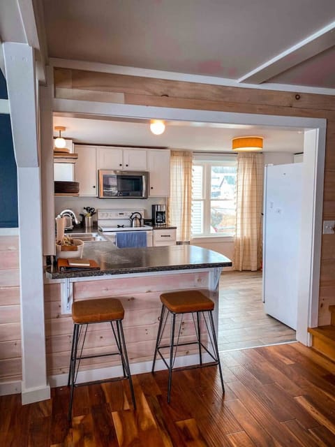 The fully stocked kitchen opens up to the living/dining area.
