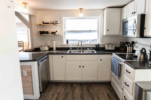 The fully stocked kitchen opens up to the living/dining area.