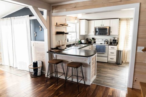 The fully stocked kitchen opens up to the living/dining area.