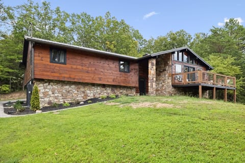 Spacious modern cabin exterior with open lawn and patio area.