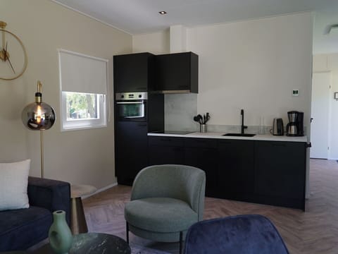 Property, Furniture, Interior Design, Comfort, Table, Floor, Living Room, Flooring, Building, Chair