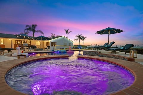 A stunning, expansive entertainer's backyard featuring a sparkling pool and luxurious spa, creating a perfect oasis for relaxation and entertainment