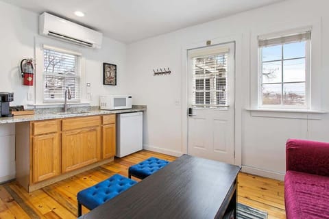 Kitchenette including microwave, private fridge and Keurig for guest use and living area in Cottage 1