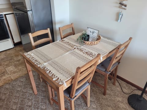 DINING AREA: The condo has a dining table and chairs for 4 adults.