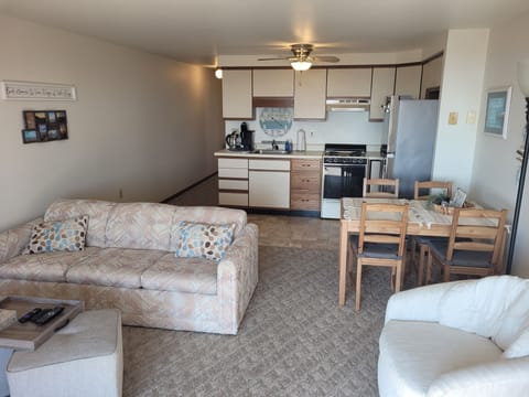 LIVING ROOM: Very comfy living room with a sofa bed, comfy chairs, ottomans, streaming television, and wall A/C unit.